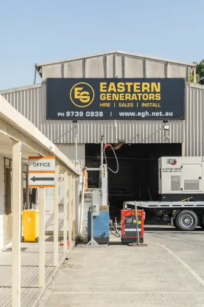 egh-pic-gray-building-black-yellow-sign-reading-2x3-1707x2560.webp