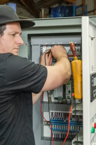 egh-pic-man-black-shirt-cap-works-electrical-2x3-1707x2560.webp