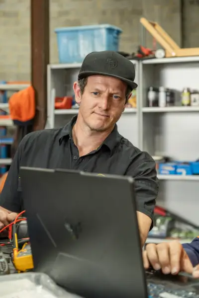 egh-pic-man-black-shirt-cap-works-laptop-2x3-1707x2560.webp
