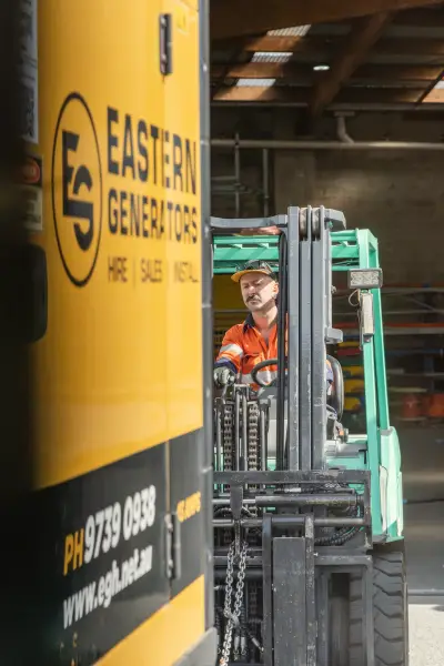 egh-pic-man-orange-shirt-cap-green-forklift-2x3-1707x2560.webp