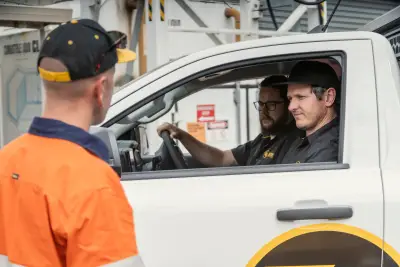 egh-pic-men-black-yellow-caps-white-truck-3x2-2560x1707.webp