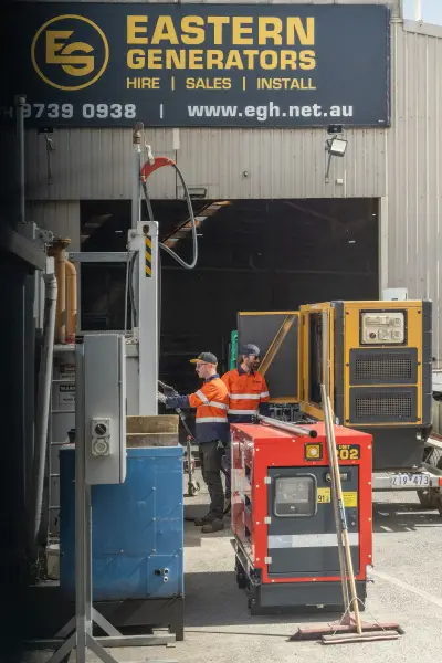 egh-pic-workers-orange-vests-generators-gray-building-2x3-1707x2560.webp