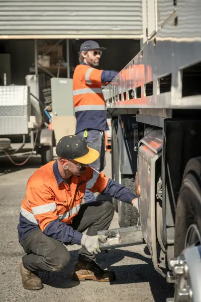 egh-pic-workers-orange-vests-hard-hats-crouched-2x3-1707x2560.webp