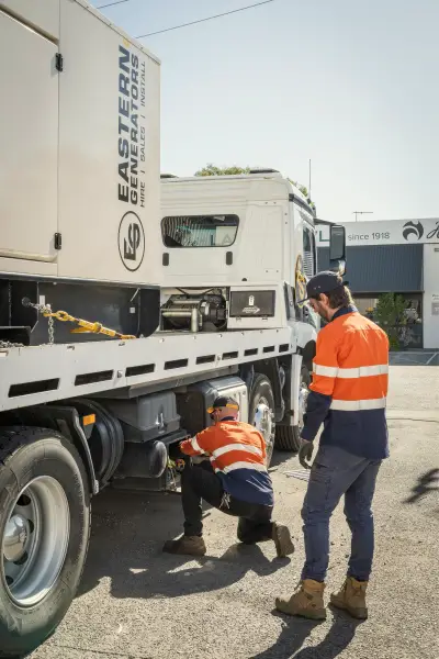 egh-pic-workers-orange-vests-inspect-undercarriage-white-2x3-1707x2560.webp